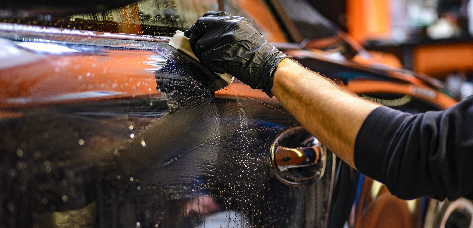 Person cleaning a car